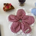 Detail eines blumenförmigen roten Gingham-Scrunchies mit weißer Spitze auf einem Tisch - Rotes Karo Spitze Blume Scrunchie