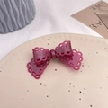 Detail view of a sparkling pink lace bow hair clip on a vintage beige ceramic plate - Rose Pink (Approx 7.2cm)