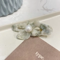 Detailed macro of vintage marble acetic hair clip with a large pearl on a ceramic tray - Beige Grey - Pearl Butterfly Duckbill Clip (Approx 5cm)