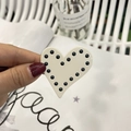 Detailed macro view of heart-shaped cream hair clip with elegant black polka dot beads - White with Black Beads