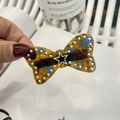 Detailed close-up of a tortoiseshell bow hair clip with pearls and silver star detail - Blue Floral Tortoiseshell