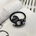 Close-up of black elastic hair tie with frosted horse charm and iridescent heart crystal - Black - Gemstone Rocking Horse