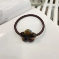 Close-up of tortoise shell resin flower elastic hair tie with gold France Handmade logo - Blue Floral Tortoiseshell