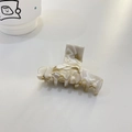 Elegant cream marble acetate hair claw clip with Barrette La France engraving on white desk - T-Shape Claw / Beige Coffee