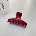 Detail view of burgundy acetate hair claw clip with golden Barrette La France lettering - T-Shape Claw / Red