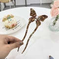 Elegant tortoiseshell acetate butterfly hair pin with pearls on a decorative table - Marble Pattern - Pearl Butterfly Hair Stick