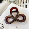 Detail showing high-quality tortoiseshell resin hair claw clip with dark amber pattern - Matte Red Brown