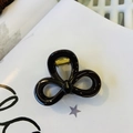 Detail view of glossy black bow hair claw clip with golden metal spring mechanism - Chocolate - Butterfly Buckle Small Bow
