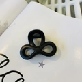 Detailed close-up of matte black triple-loop bow hair claw with durable metal spring - Matte Black - Butterfly Buckle Small Bow
