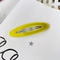 Detail of yellow oval acetate hair clip with Barrette La France engraved lettering - Yellow Jelly