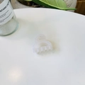 Minimalist translucent white small hair claw clip with curved teeth on a white table - Hollow Lock Butterfly Buckle / Jelly White