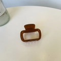 Detail of amber acetate hair claw clip with gold Creation France lettering on white background - Small Size (approx. 5cm) / Light Transparent Brown