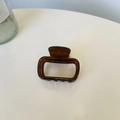 Detail of a brown acetate rectangle hair claw clip with Creation France gold lettering - Small Size (approx. 5cm) / Deep Transparent Coffee