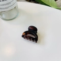 Gros plan sur une pince à cheveux motif tortue avec une texture ambre et marron au centre - Serrure Creuse Boucle Papillon / 4cm / Marron Rouge Brillant
