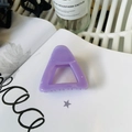 Detail of a glossy purple hollow triangle claw clip placed on a magazine for styling - Approx 6cm / Taro Purple