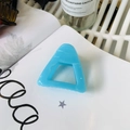 Close-up of light blue hollow triangle hair claw clip on white magazine background - Approx 6cm / French Blue