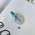 Detail of candy-colored traceless hair clip with a blue ribbon bow and cartoon cat motif - Blue And Pink Oval Cat No Mark Clip