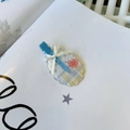 Detail of blue candy-colored hair clip with ribbon bow and floral acrylic pattern - Blue And White Oval Striped No Mark Clip
