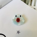 Detailed close-up of a cute handmade green frog hair clip with marble texture acetate - Frog Duckbill Clip
