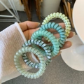 Five elastic telephone wire hair ties in pastel green and yellow with checkerboard pattern - Emerald Green Style