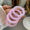 Close-up of pink spiral phone cord hair ties set with polka dots and elastic resin - Pink Guava Lemon Style