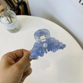 Detailed close-up of translucent blue acetate hair claw with floral relief and pearl decoration - Elegant Blue Pearl Petal