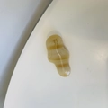 Detail view of wavy amber resin hair clip with SUNSHINE handmade text engraving - Cream