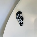 Close-up of handmade irregular black and white marble acetate hair clip with gold text - Black and White Speckled