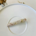 Detail showing marble texture resin hair clip with gold metal base and Barrette text - Lotus Pink Green