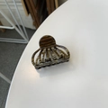 Detail of tortoise shell acetate hair claw clip showing Creation France engraving - Brown Reef Pattern