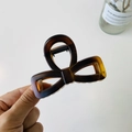 Detail of a large dark brown tortoiseshell butterfly hair claw clip held by hand - Matte Tortoise - Bow Buckle Square Bow