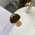 Detail shot of cute mushroom resin hair clip in dark brown and apricot on white card - Mushroom