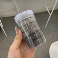 Ensemble d'élastiques à cheveux en peluche grise dans un contenant cylindrique en plastique - Dégradé Gris Peluche Solide