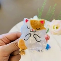 Detail of a cute cat-shaped hair claw clip made from marbled acetate with orange patches - Blessing Cat