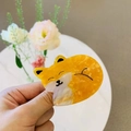 Detailed close-up of a yellow cat-shaped acetate hair claw clip with marble texture - Lying Fox
