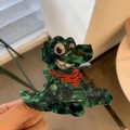 Detail of green marble-textured crocodile hair claw clip with a cute red scarf - Dinosaur with Red Scarf
