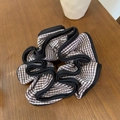 Classic brown and white gingham scrunchie with black trim on a wooden background - Coffee Plaid