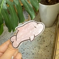 Detailed view of an acetate dolphin hair claw with a pearlescent pink finish texture - Cartoon Dolphin