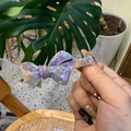 Detailed close-up of a handmade acetate bow hair clip with purple marble texture finish - Purple Marbled Floral Bowknot