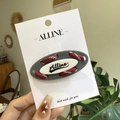 Alline minimalist oval hair clip with red and white woven cord design in hand - Gray Base Red Rope