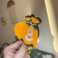 Pinza per capelli a forma di sacchetto di soldi arancione e nero con simbolo del dollaro - Sacco di Soldi Arancione
