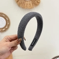 Close-up of handmade grey knitted headband showing thick texture and inner label - Gray