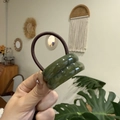 Detailed macro view of dark green resin oval rings and brown elastic hair tie - Double Layer Oval / Verdant