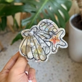 Detailed view of ocean-themed shell and starfish hair claw with pearls and acetate finish - Black and White Textured Pearl Shell Starfish