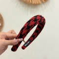 Detailed texture of red and black houndstooth tweed headband with Hand Made label - Black Red Thread Cross Texture
