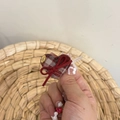 Detail of red plaid heart hair accessory with a bow and gold Love metal tag - Red Heart Duckbill Clip