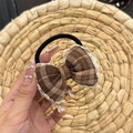 Detail of a brown plaid hair scrunchie with lace edges and a vintage bow design - Khaki Plaid Scrunchie