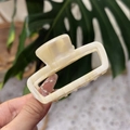 French style acetate hair claw clip with marble texture and gold Barrette France logo - Cream White
