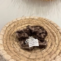 Close-up of brown plaid hair scrunchie with white pearl beads and handmade fabric label - Brown Bow Pearl Scrunchie