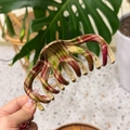 Close-up of a large red and green plaid hair claw clip with elegant tartan resin pattern - Red Green Plaid - Keel Claw